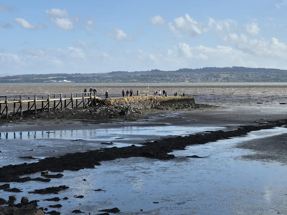 Culross Pier viewed from the West at low water. Notice the rocks around the base of the pier.